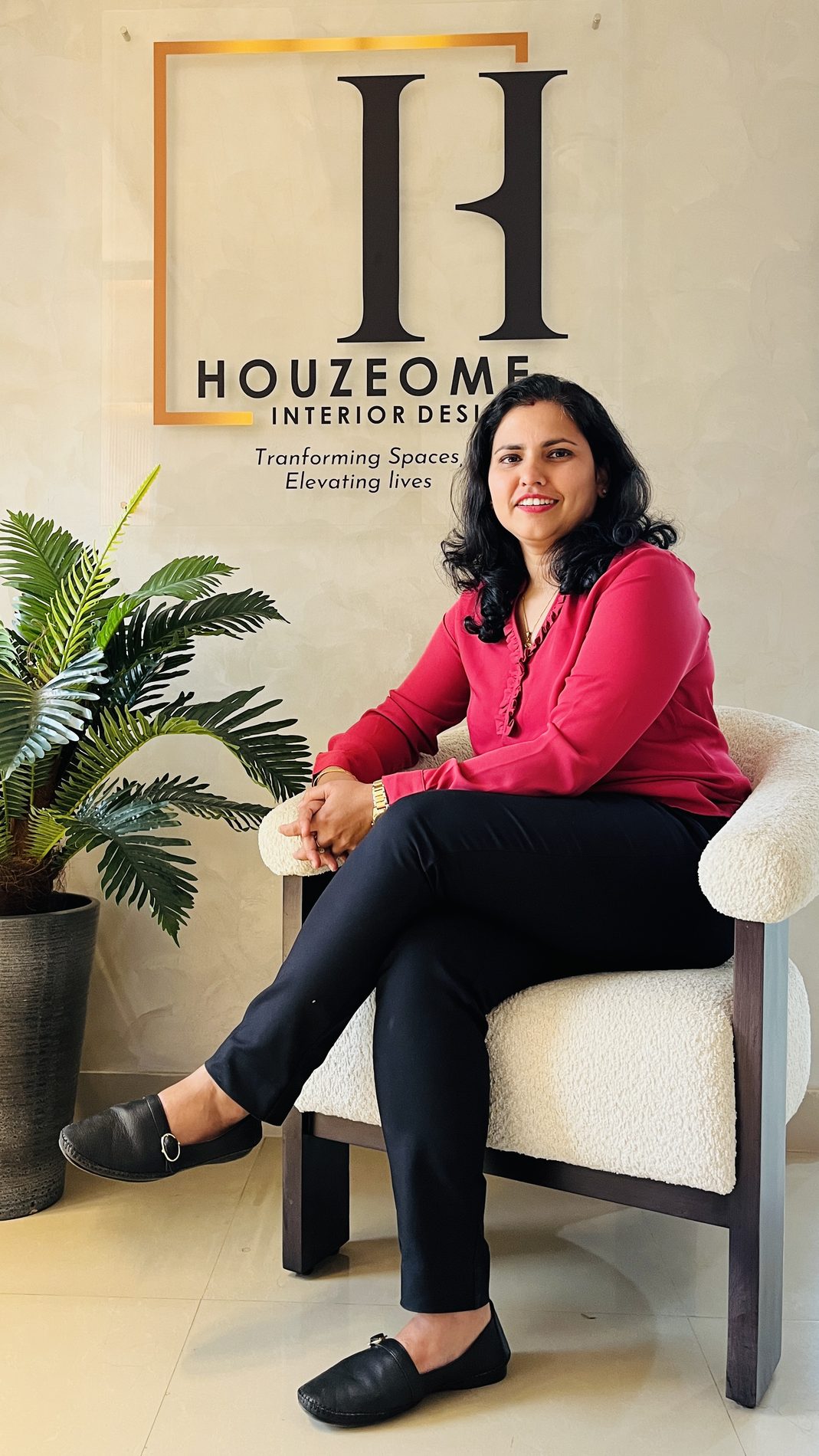Ipsita, founder of Houzeome, at the studio beneath the Houzeome sign