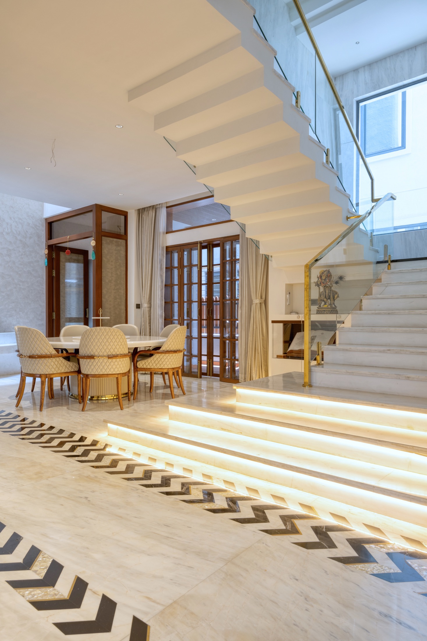 Modi Villa dining area beneath the floating staircase