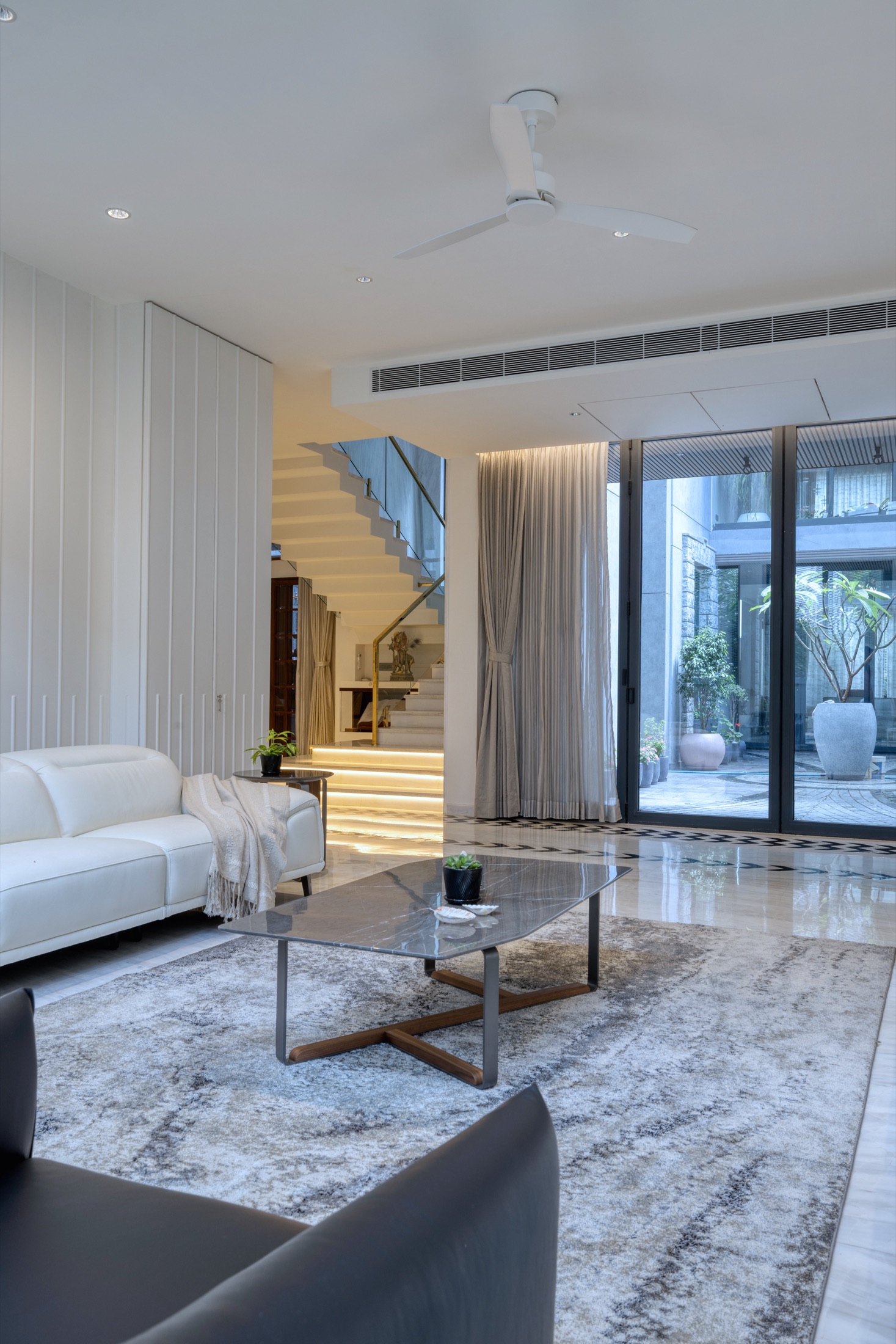 Modi Villa living space with floating staircase and courtyard, HSR Layout